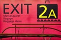 Exit information signal post at airport terminal. Travel background