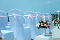 Exit registration of the newlyweds, wedding ceremony under open sky. Seating guests. Rows of chairs with white capes, close up Royalty Free Stock Photo