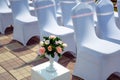 Exit registration of the newlyweds, wedding ceremony under open sky. Seating guests. Rows of chairs with white capes, close up