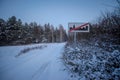 Road sign - End of the Built-up Area - a village in the middle of the forests (Czarna Glina) in a snowy landscape.