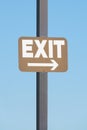 Exit sign attached to a post against blue sky background. Business concept Royalty Free Stock Photo