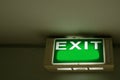 Exit sign hanging on the ceiling with copy space Royalty Free Stock Photo