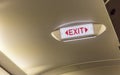 Exit sign on overhead in passenger airplane Emergency Exit Row i