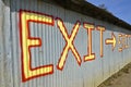 Exit sign painted on steel building