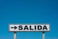 Exit sign spanish: SALIDA on blue sky -