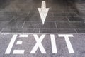 Exit text with arrow painted on the floor
