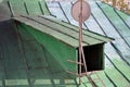 Exit to old green metal roof with antenna