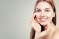 Exited beautiful woman with healthy clear skin applying moisturizing cream on her face, closeup portrait. Skin care Royalty Free Stock Photo