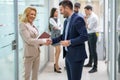 Exited business partners handshake making deal agreement after successful negotiation in office. Royalty Free Stock Photo