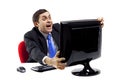 Exited businessman in front of a computer monitor