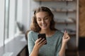Exited young woman read good news on cellphone Royalty Free Stock Photo