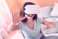 Smiling girl using virtual reality device at home Royalty Free Stock Photo