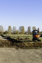 Rural landscape with a tractor , earth movers in field Royalty Free Stock Photo