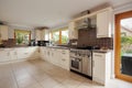 Modern fitted kitchen with tiled floor