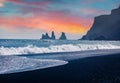 Exoti summer sunrise on Reynisdrangar cliffs in Atlantic ocean. Exciting morning scene of black sand beach in Iceland, Vik locatio