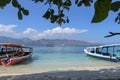 Exotic beach with palms and boats on azure water. Beautiful view over a Gili island in Indonesia. White sandy beach Royalty Free Stock Photo