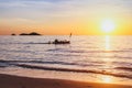Exotic beach at sunset with silhouette of fisherman boat, inspiring tropical landscape Royalty Free Stock Photo