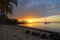 exotic beach, with view of the sunset, and sailboats in the distance