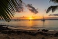 exotic beach, with view of the sunset, and sailboats in the distance