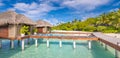 Exotic beach with water bungalows at Maldives, wooden bridge into paradise island Royalty Free Stock Photo