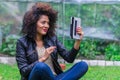 Exotic beautiful young girl sitting in the garden Royalty Free Stock Photo