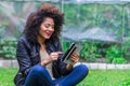 Exotic beautiful young girl sitting in the garden Royalty Free Stock Photo