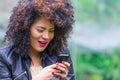 Exotic beautiful young girl using cell phone Royalty Free Stock Photo