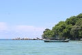 Exotic boat saling on clear beautiful beach island under the blue sky Royalty Free Stock Photo