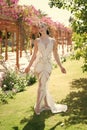 Exotic bride. Girl attractive expensive dress. Lady in luxury outfit walks exotic garden background. Woman make up Royalty Free Stock Photo