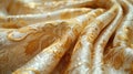 An exotic brocade fabric, with a focus on its rich, decorative patterns, woven with golden threads, set against a clean Royalty Free Stock Photo