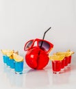 Exotic drink in a ball-shaped glass, eight drinks in a shotglass, sunglasses Royalty Free Stock Photo