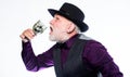 Exotic food. Cocktail with real spiders. Alcohol drink and bar. Bearded old guy hold wineglass with spider inside Royalty Free Stock Photo