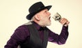 Exotic food. Cocktail with real spiders. Alcohol drink and bar. Bearded old guy hold wineglass with spider inside Royalty Free Stock Photo