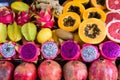 Exotic summer fruits laid out in shopping mall or market. Dragon fruit, pineapple, persimmon, mango, annona cherimola Royalty Free Stock Photo