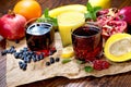 Exotic fruit juice, choke berry juice, aronia juice, pomegranate juice, banana smoothie and organic fruits on table Royalty Free Stock Photo