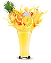Exotic fruit juice splash. Whole and sliced pineapple, orange, limon, peach, banana and dragon fruit in a sweet juce or cocktail