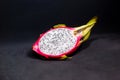 Exotic fruits from Asia: half pitahaya on a dark background