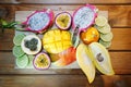 Exotic fruits lying on a wooden table studio photo.