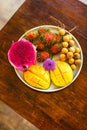Exotic fruits on plate: mango, dragon fruit; mango; pineapple an Royalty Free Stock Photo