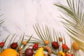 Exotic fruits and tropical palm leaves