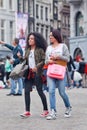 Exotic girls walk at Dam Square, Amsterdam, Netherlands