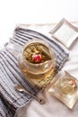 Exotic Green Tea Glass Teapot with Floral Blooming Tea Ball on White Table Royalty Free Stock Photo