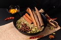 Exotic herbal Food concept Mix of the organic Spices cinnamon stick, cardamom pods, cloves, star anise and fennel seeds in slilet Royalty Free Stock Photo