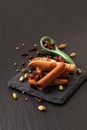 Exotic herbal Food concept Mix of the organic Spices cinnamon stick, cardamom pods, star anise and coriander seeds on a black Royalty Free Stock Photo