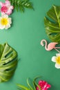 Exotic jungle summer frame. Summer beach party concept. Pink flamingo, tropical leaf monstera and orchid flowers on green