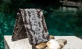 Exotic and luxury of hand made leather wallet, purse .Multi colored.Leather craft. On a stone tile with background with Plumeria