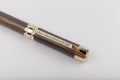 Exotic, Luxury Iroko wood bolt-action pen with chrome metal fixtures and beautiful knot in the wood - Product Photo