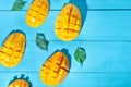 Exotic mango tropical fruit cutted on blue background Royalty Free Stock Photo