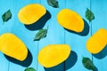 Exotic mango tropical fruit cutted on blue background Royalty Free Stock Photo