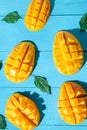 Exotic mango tropical fruit cutted on blue background Royalty Free Stock Photo